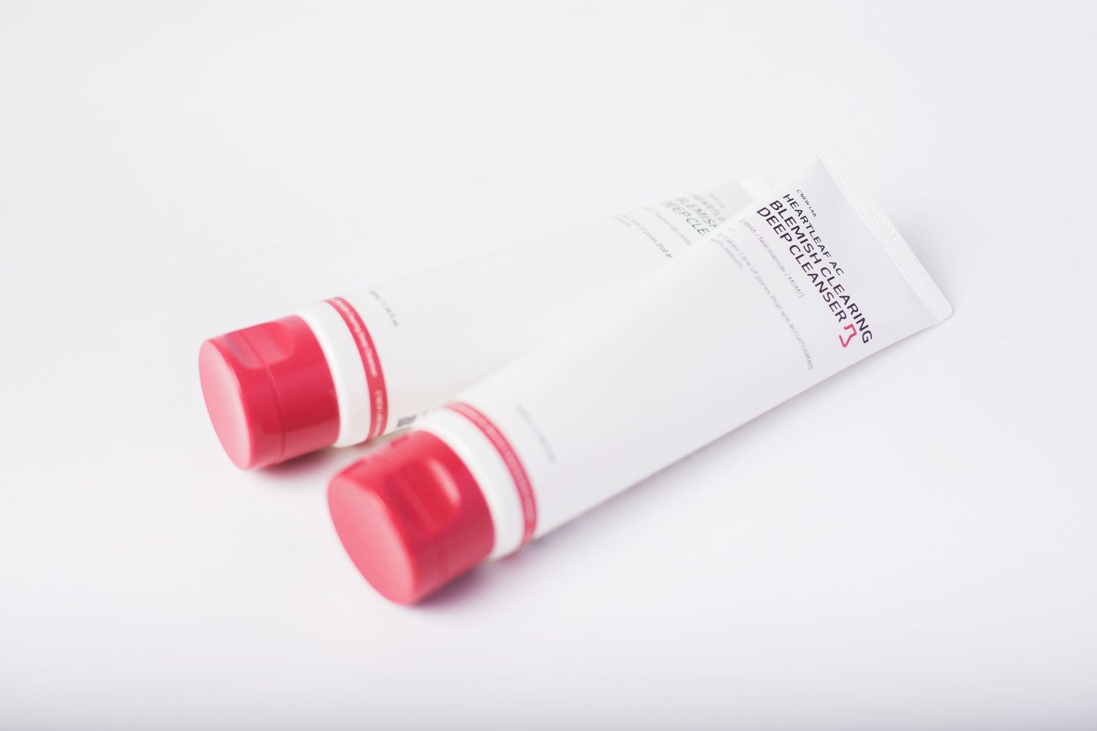 An unbranded bottle of lotion on a clean surface.